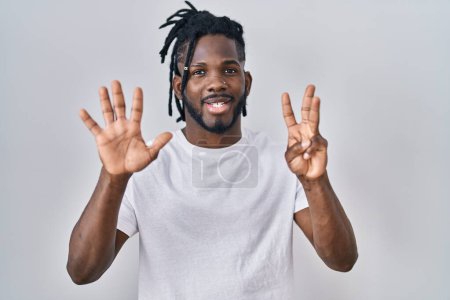 Photo for African man with dreadlocks wearing casual t shirt over white background showing and pointing up with fingers number eight while smiling confident and happy. - Royalty Free Image