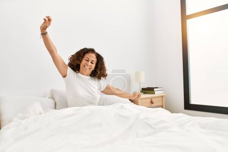 Photo for Middle age hispanic woman smiling confident waking up at bedroom - Royalty Free Image