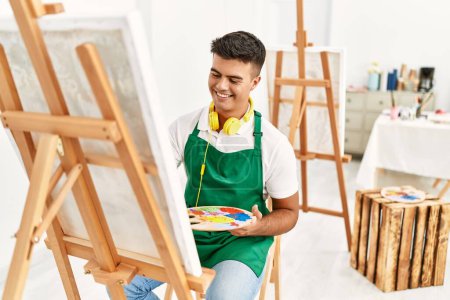 Photo for Young hispanic man smiling confident drawing at art studio - Royalty Free Image