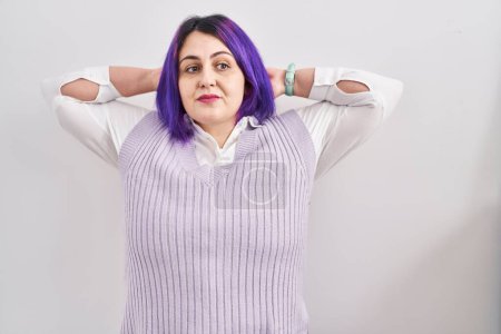 Téléchargez les photos : Plus size woman wit purple hair standing over white background relaxing and stretching, arms and hands behind head and neck smiling happy - en image libre de droit