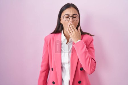 Photo for Young hispanic woman wearing business clothes and glasses bored yawning tired covering mouth with hand. restless and sleepiness. - Royalty Free Image