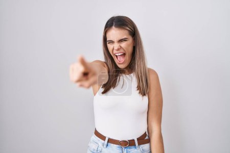 Photo for Hispanic young woman standing over white background pointing displeased and frustrated to the camera, angry and furious with you - Royalty Free Image