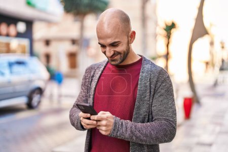 Photo for Young man smiling confident using smartphone at street - Royalty Free Image