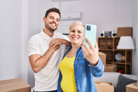 Photo for Mother and son make selfie by the smartphone at new home - Royalty Free Image