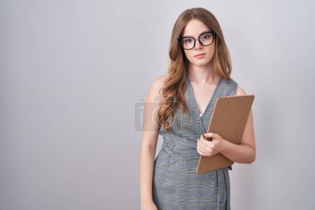 Photo for Caucasian woman wearing glasses and business clothes relaxed with serious expression on face. simple and natural looking at the camera. - Royalty Free Image