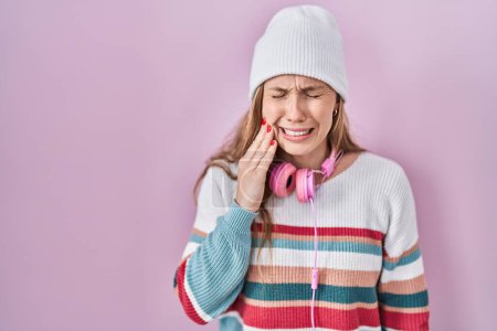 Photo for Young blonde woman standing over pink background touching mouth with hand with painful expression because of toothache or dental illness on teeth. dentist - Royalty Free Image