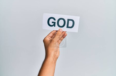 Foto de Hand of caucasian man holding paper with god word over isolated white background - Imagen libre de derechos