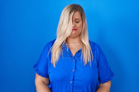 Photo for Caucasian plus size woman standing over blue background depressed and worry for distress, crying angry and afraid. sad expression. - Royalty Free Image