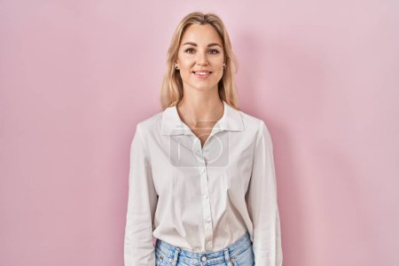 Photo for Young caucasian woman wearing casual white shirt over pink background with a happy and cool smile on face. lucky person. - Royalty Free Image