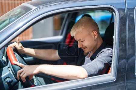 Photo for Young caucasian man smiling confident driving car at street - Royalty Free Image