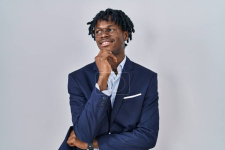 Photo for Young african man with dreadlocks wearing business jacket over white background with hand on chin thinking about question, pensive expression. smiling and thoughtful face. doubt concept. - Royalty Free Image
