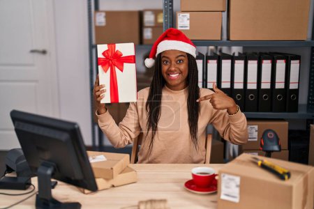 Photo for Young african american with braids working at small business ecommerce at christmas pointing finger to one self smiling happy and proud - Royalty Free Image