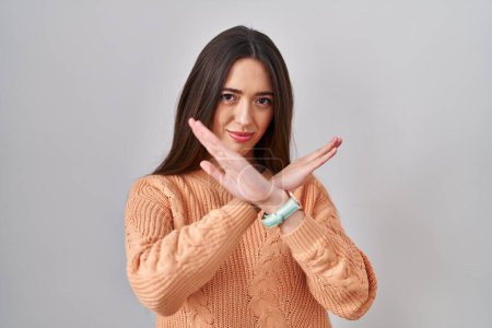Photo for Young brunette woman standing over white background rejection expression crossing arms doing negative sign, angry face - Royalty Free Image