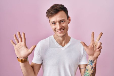 Photo for Caucasian man standing over pink background showing and pointing up with fingers number eight while smiling confident and happy. - Royalty Free Image