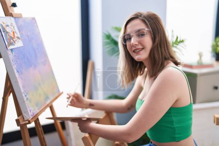 Foto de Young woman artist smiling confident drawing at art studio - Imagen libre de derechos