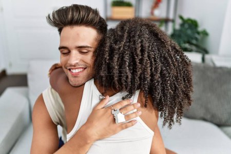 Téléchargez les photos : Homme et femme couple souriant confiant s'embrasser à la maison - en image libre de droit