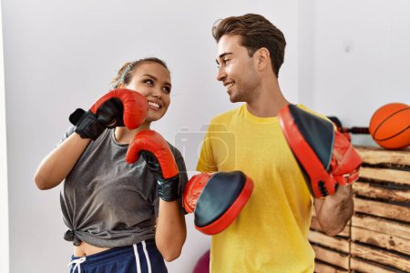 Photo for Man and woman couple smiling confident boxing at sport center - Royalty Free Image