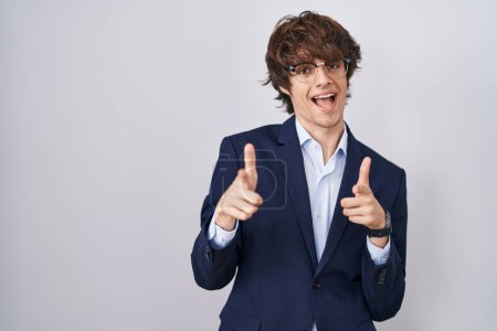 Photo for Hispanic business young man wearing glasses pointing fingers to camera with happy and funny face. good energy and vibes. - Royalty Free Image