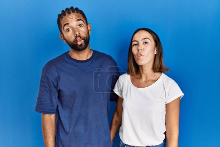 Photo for Young hispanic couple standing together making fish face with lips, crazy and comical gesture. funny expression. - Royalty Free Image