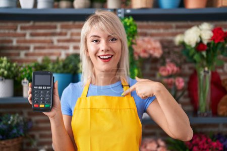 Photo for Young caucasian woman working at florist shop holding dataphone pointing finger to one self smiling happy and proud - Royalty Free Image