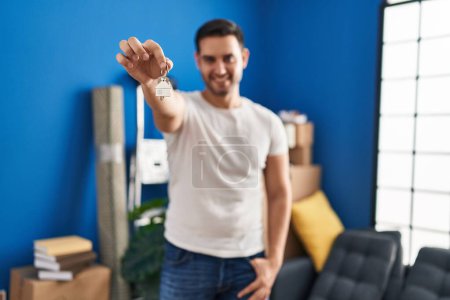 Photo for Young hispanic man smiling confident holding key at new home - Royalty Free Image