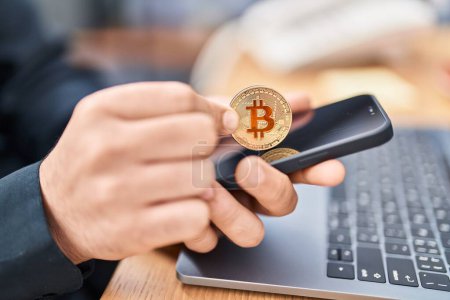 Photo for Young man business worker inserting bitcoin on smartphone at office - Royalty Free Image