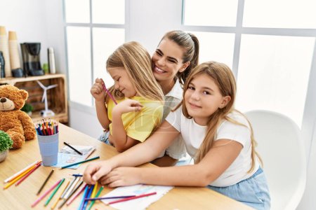 Photo for Mother and daughters smiling confident drawing at home - Royalty Free Image