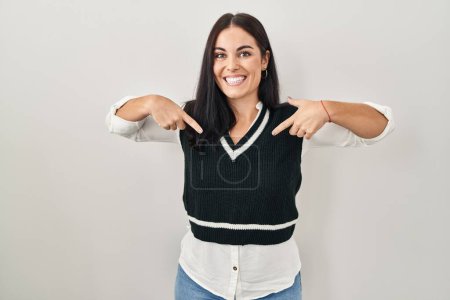 Photo for Young hispanic woman standing over isolated background looking confident with smile on face, pointing oneself with fingers proud and happy. - Royalty Free Image
