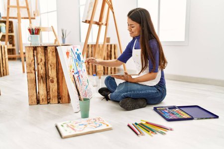 Photo for Young latin woman smiling confident drawing at art studio - Royalty Free Image