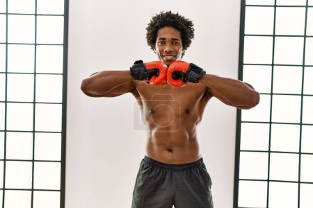 Photo for Young african american man smiling happy boxing at gym - Royalty Free Image
