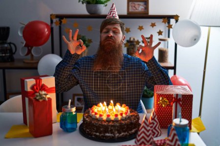 Photo for Caucasian man with long beard celebrating birthday holding big chocolate cake relax and smiling with eyes closed doing meditation gesture with fingers. yoga concept. - Royalty Free Image