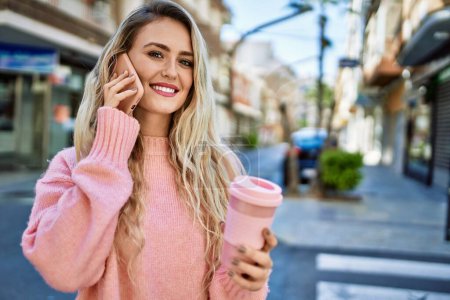 Photo for Young blonde woman speaking on the phone at the city - Royalty Free Image