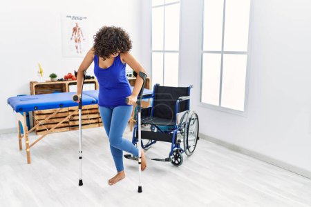 Photo for Young middle east woman walking using crutches at clinic - Royalty Free Image