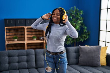 Photo for African american woman listening to music standing at street - Royalty Free Image