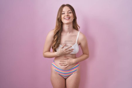 Photo for Caucasian woman wearing lingerie over pink background smiling and laughing hard out loud because funny crazy joke with hands on body. - Royalty Free Image