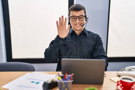 Photo for Young arab man wearing call center agent headset looking positive and happy standing and smiling with a confident smile showing teeth - Royalty Free Image