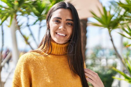 Téléchargez les photos : Jeune femme hispanique souriant confiance debout au parc - en image libre de droit