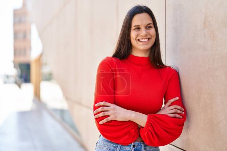 Photo for Young beautiful hispanic woman standing with arms crossed gesture at street - Royalty Free Image