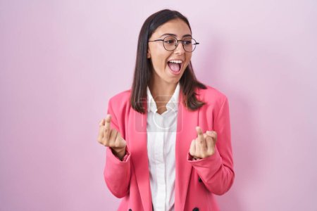 Photo for Young hispanic woman wearing business clothes and glasses showing middle finger doing fuck you bad expression, provocation and rude attitude. screaming excited - Royalty Free Image
