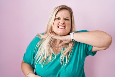 Caucasian plus size woman standing over pink background cutting throat with hand as knife, threaten aggression with furious violence 