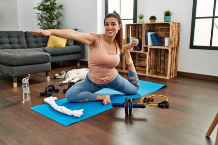 Photo for Young woman smiling confident training yoga at home - Royalty Free Image