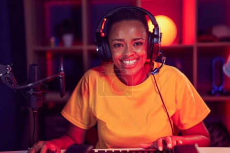 Photo for African american woman streamer playing video game using computer at gaming room - Royalty Free Image