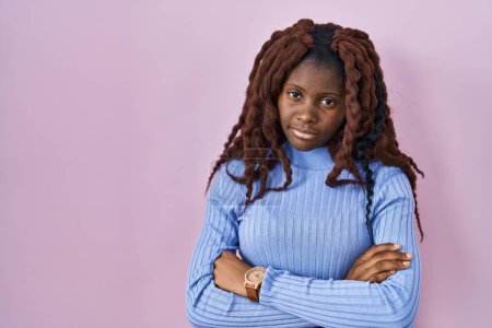 Foto de African woman standing over pink background looking sleepy and tired, exhausted for fatigue and hangover, lazy eyes in the morning. - Imagen libre de derechos