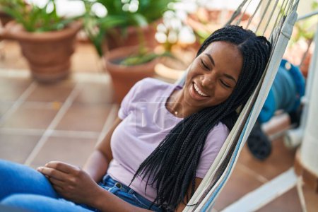 Photo for African american woman smiling confident lying on hammock at home terrace - Royalty Free Image