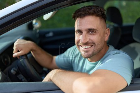 Photo for Young hispanic man smiling confident driving car at street - Royalty Free Image