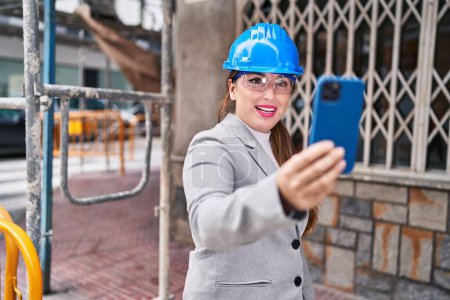 Photo for Young beautiful hispanic woman architect smiling confident having video call at street - Royalty Free Image