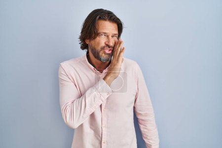 Photo for Handsome middle age man wearing elegant shirt background hand on mouth telling secret rumor, whispering malicious talk conversation - Royalty Free Image