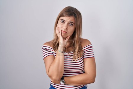 Photo for Young hispanic woman standing over isolated background looking stressed and nervous with hands on mouth biting nails. anxiety problem. - Royalty Free Image