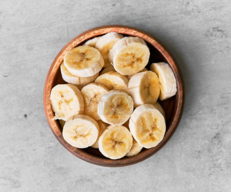 Photo for Photo of banana slices in a bowl on a concrete surface - Royalty Free Image