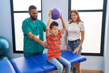 Family having rehab session using ball at rehab clinic